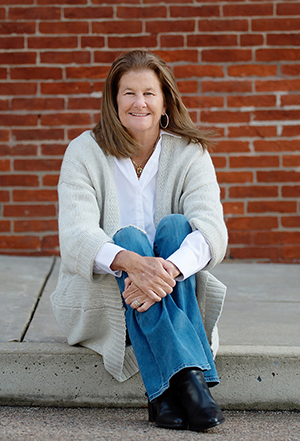 Jackie smiling on the curb outside