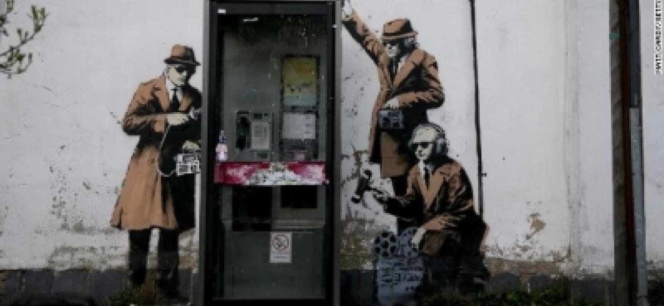 Is it a Banksy? UK street art image appears to show spies at work
