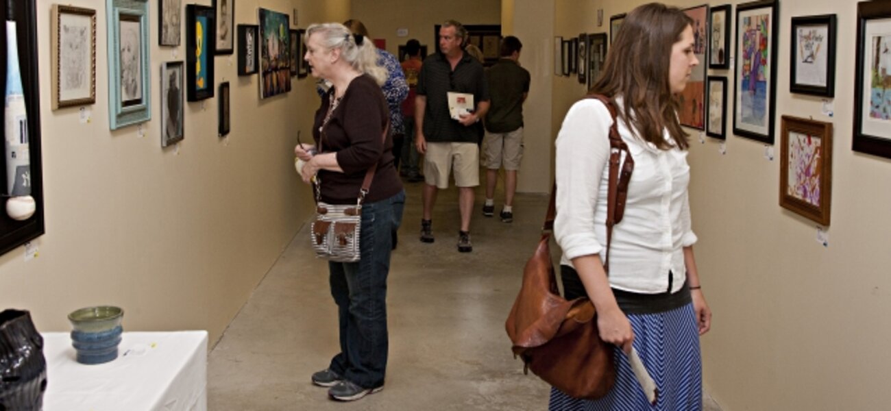 4th Annual Exhibit Attendees taking in the employee artwork on display at the Avera Prairie Center.