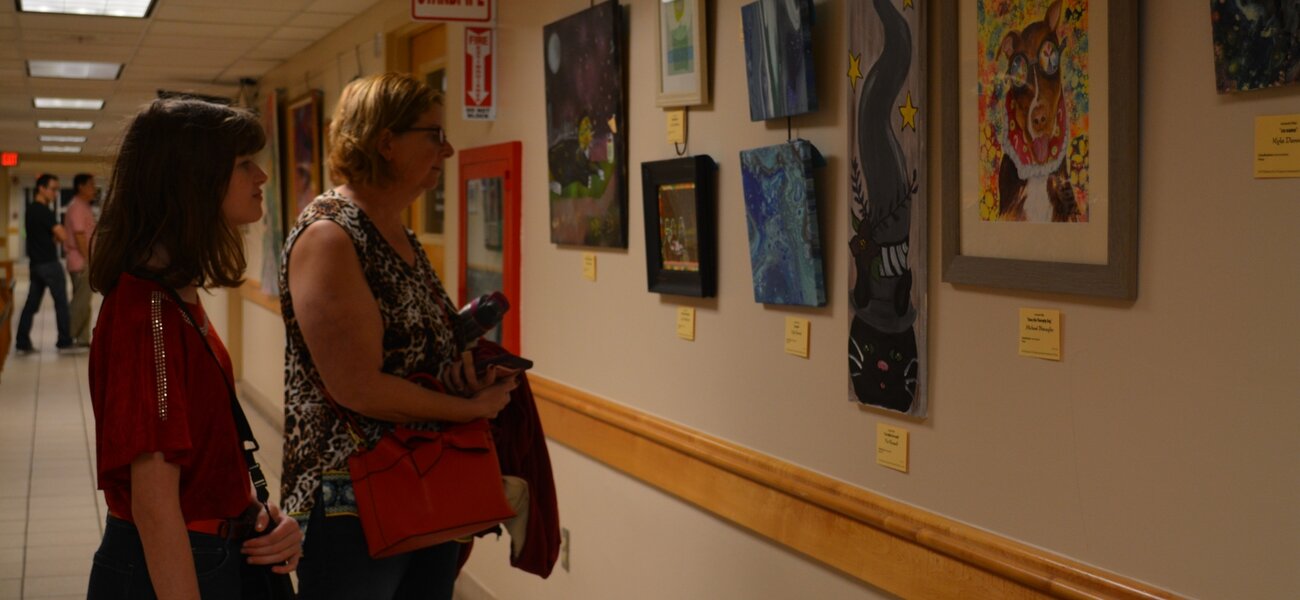 15th Annual Exhibit Attendees taking in the artwork at the Seminole County Services Building