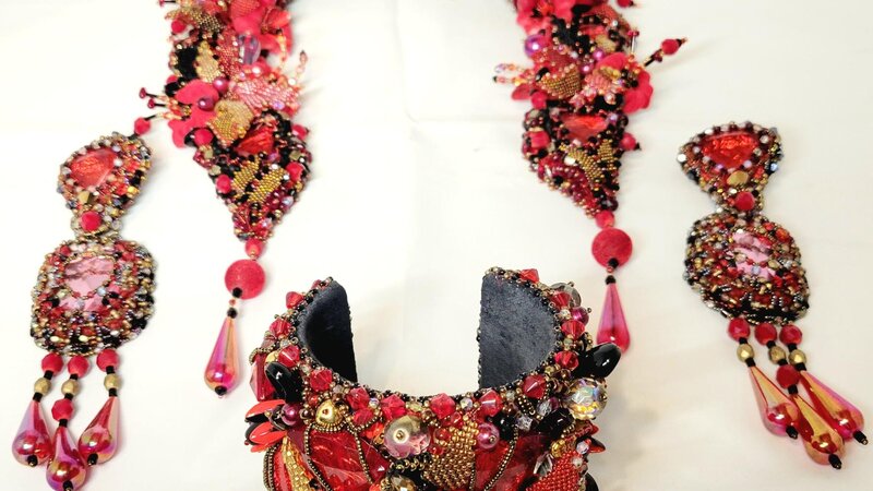 Jewelry set: necklace, bracelet, earrings with various beads and crystals.