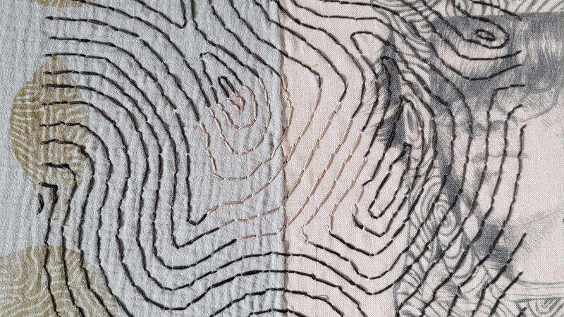 Mixed media piece with a self portrait on one side and symbols on the other.  the entire piece is covered in a organic pattern that flows through the piece, only broken up by the circle of lighter thread in the middle.