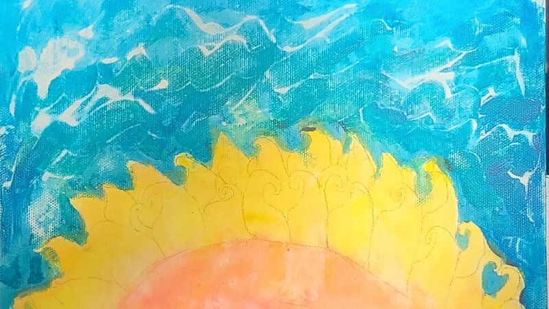 The sun blooming over the ocean