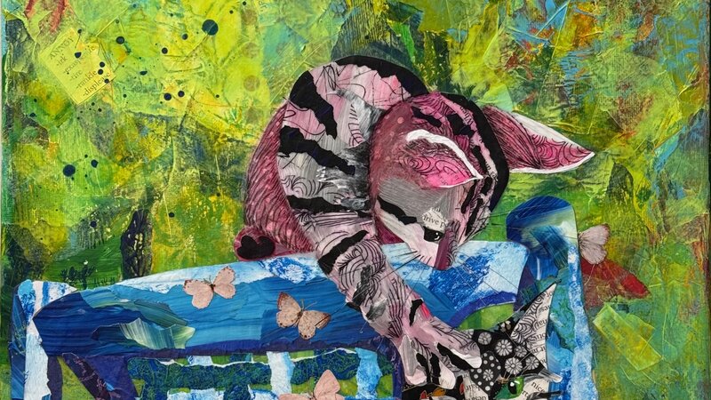 Torn paper collage of two playful cats on a blue chair