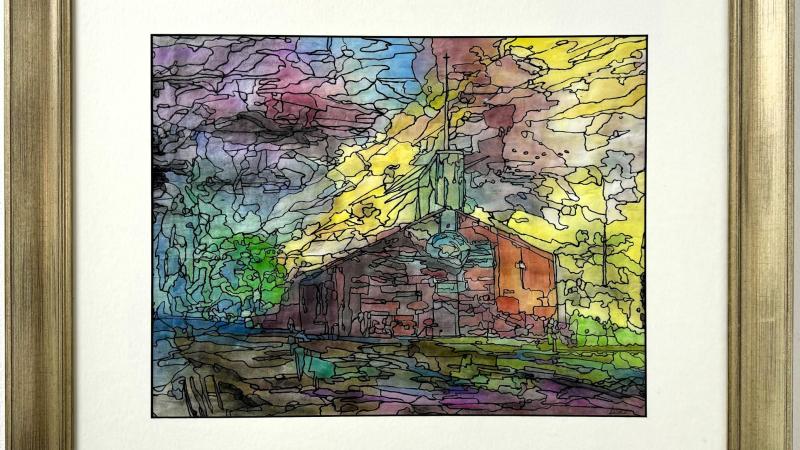 church backlit by colorful sunset 