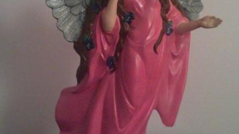 Angel standing with violets 