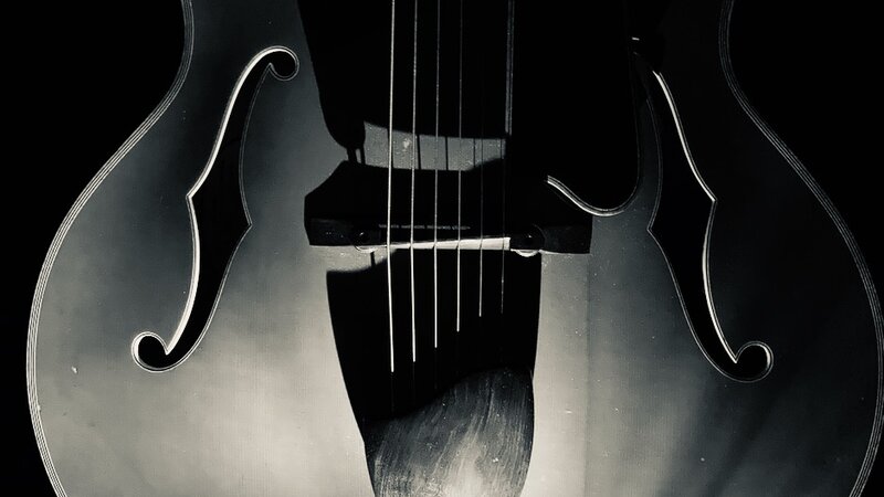 Late night photo of Eastman archtop  jazz guitar, 2022. I used an iPhone SE with illumination.