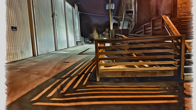 Shadows cast at night from the dock of an old warehouse.