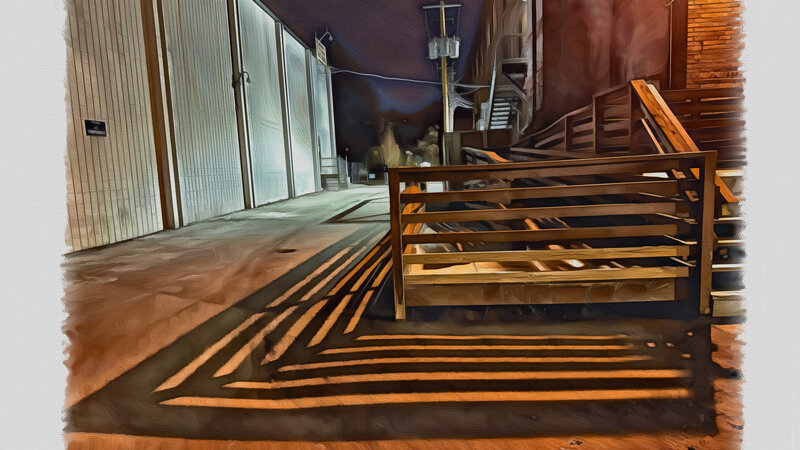 Shadows cast at night from the dock of an old warehouse.