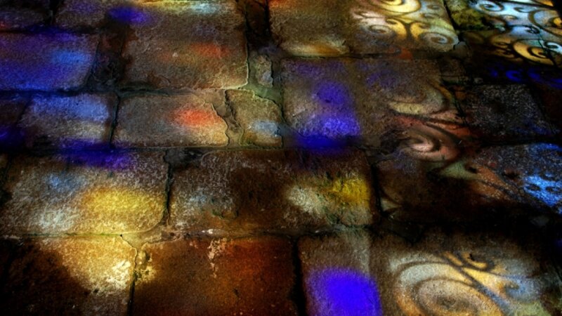 Medieval chapel floor with stained glass windowlight
