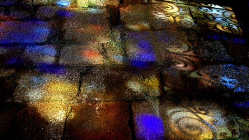 Medieval chapel floor with stained glass windowlight