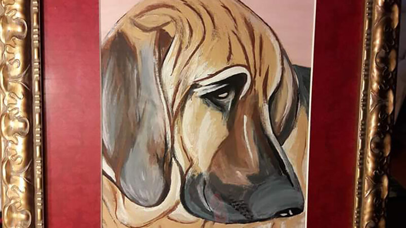 Canvas portrait of large hound dog with red matte and gold frame.