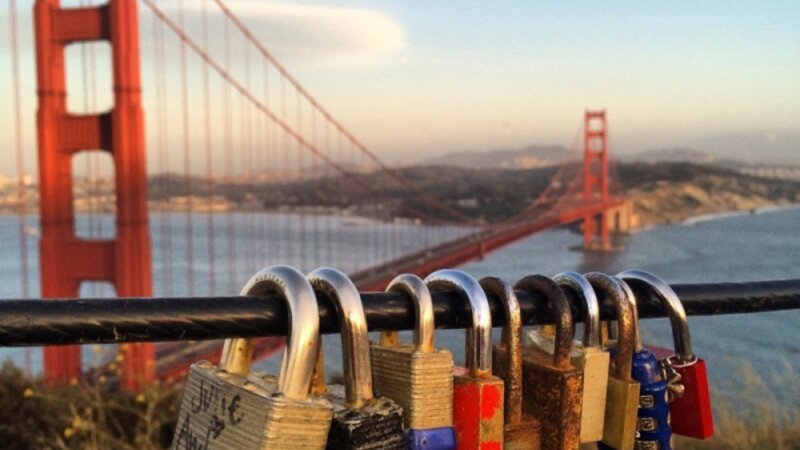 Love locks passing by with a hug and a kiss to San Francisco Bay
