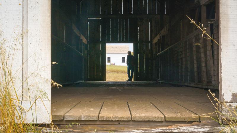 Man in barn door