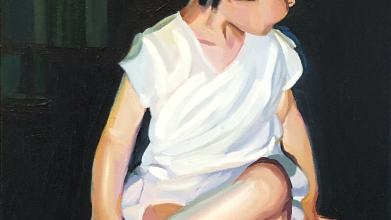 A two year old mid century girl dressed in white. She's turning away from the camera and wearing black Mary Janes.  The background is black. 