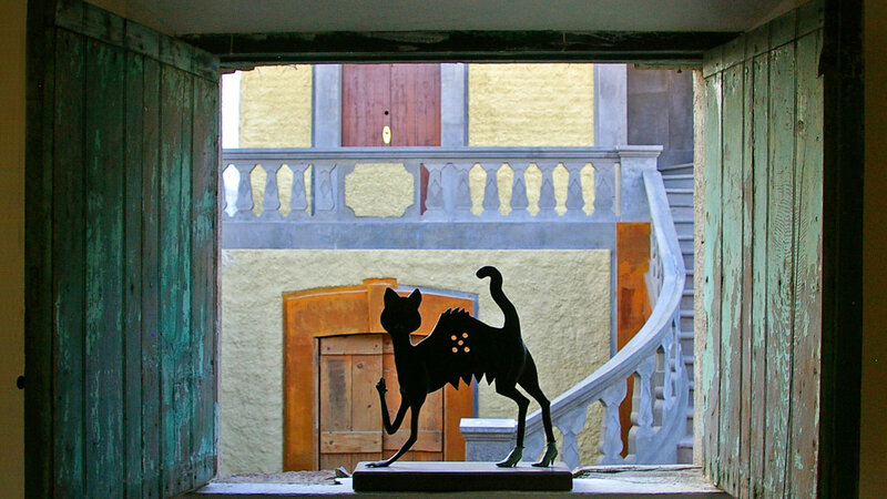A cat in the window of a house in Mexico