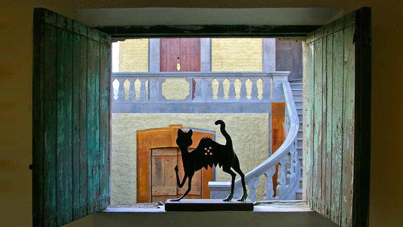 A cat in the window of a house in Mexico