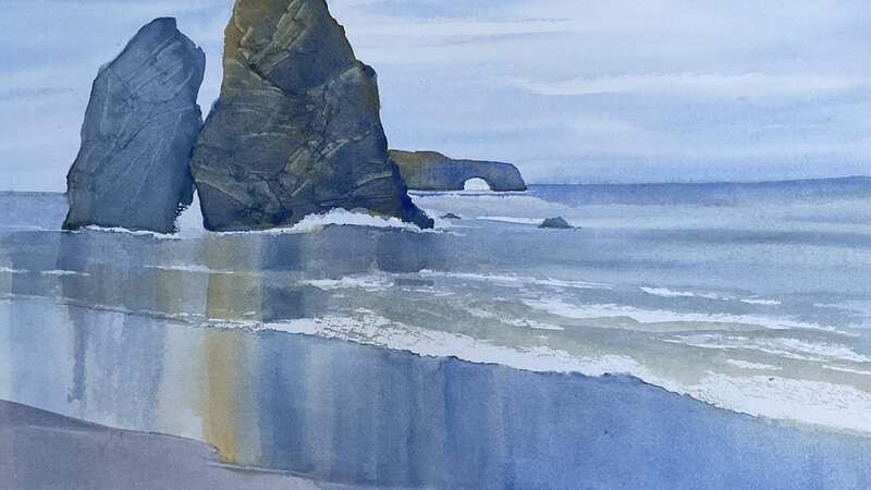 Sonoma coast depicting reflections of Split Rock in the wet sand.