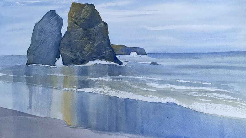 Sonoma coast depicting reflections of Split Rock in the wet sand.