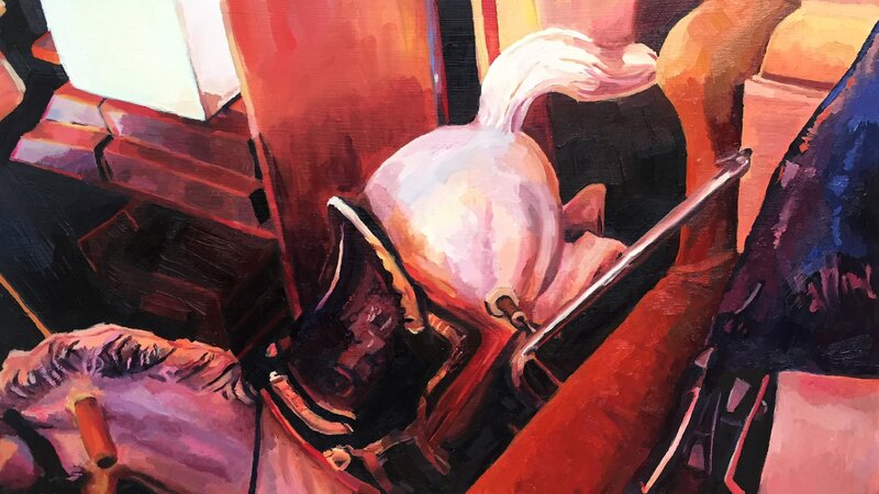 A cluttered basement with a white rocking horse thrown in the corner. The light is setting through a basement window. 