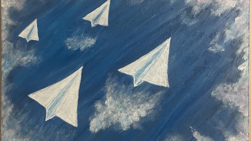 paper planes flying through the sky 