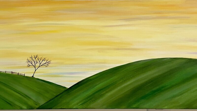golden sky with moon. Rolling green hills with one tree