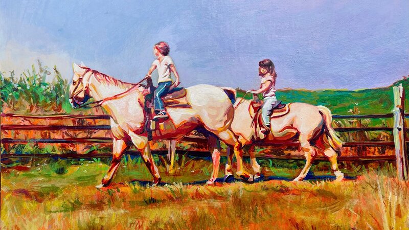 Two little girls from afar on white horses. And older girl is leading in the front. The landscape around them is colorful and dry, like a dessert. 