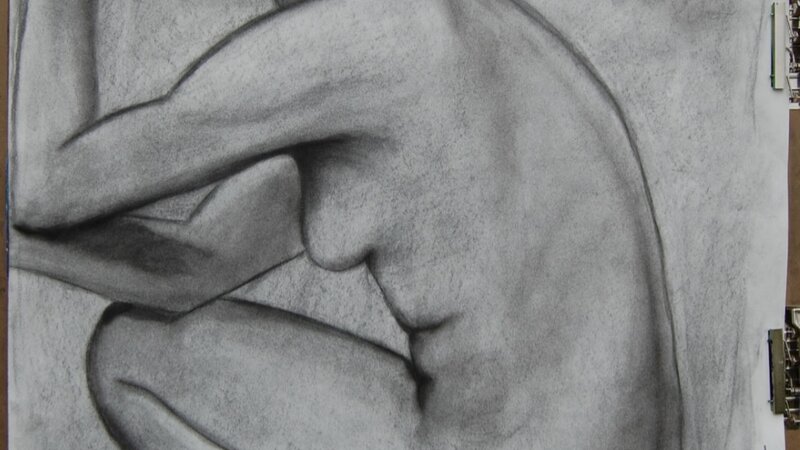 The left side silhouette of a woman in a crouched position, elbows on knees, and hands up to the face. Only the woman’s chin is in the frame, and on the bottom, the woman’s feet, calves, and bottom are cropped out of the frame. 