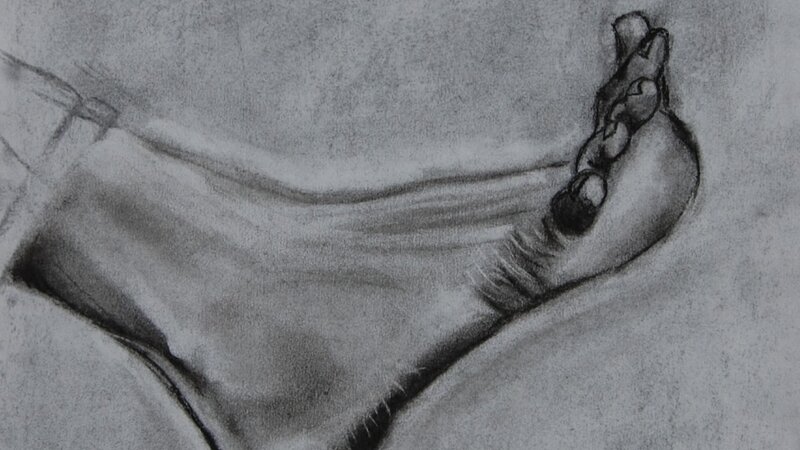 A charcoal drawing of a flexed foot.