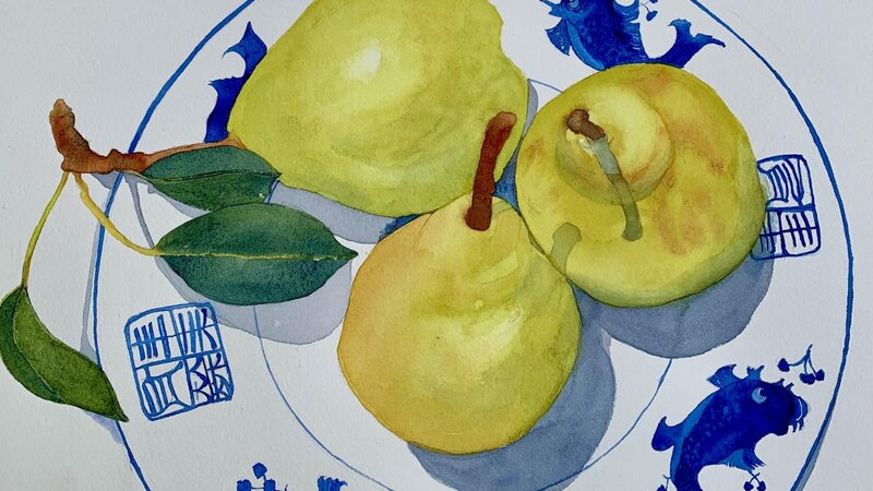 3 yellow pears on a white dish with blue koi pattern