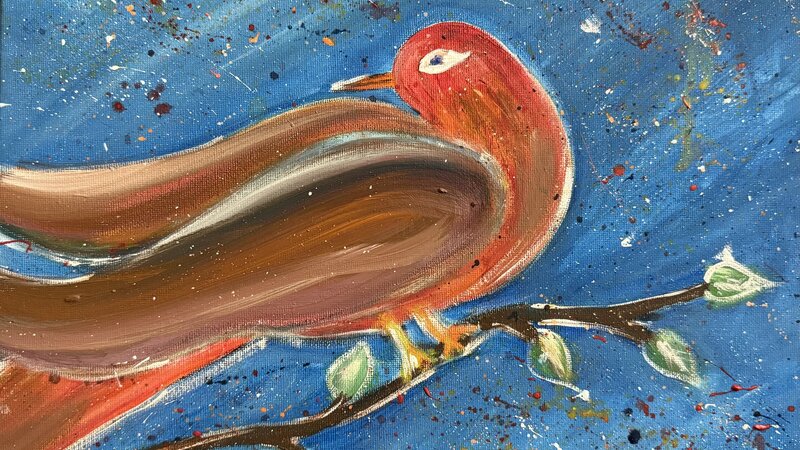  red bird on a branch with fire works in the sky 