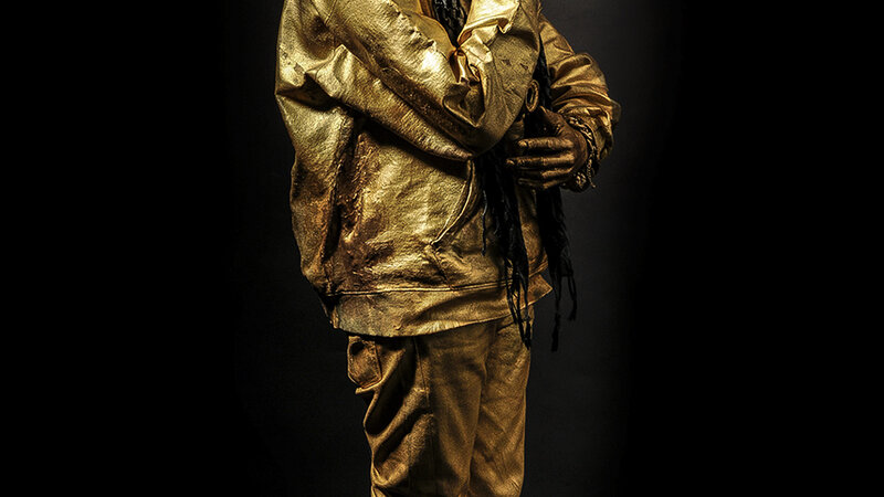 gold figure standing tall with head turned. right hand under chin , left hand under elbow