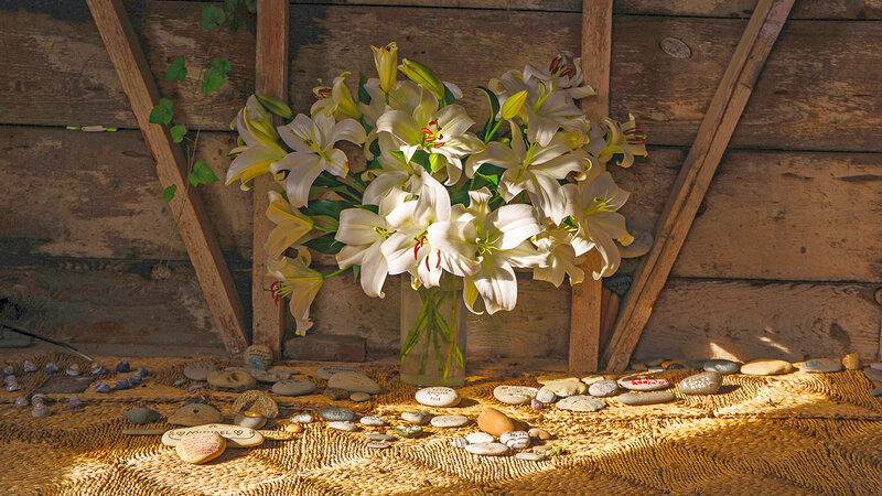 Lilies in a vase on a floor