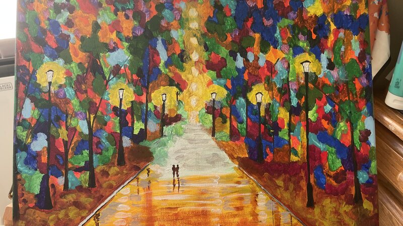 Multicolored street scene with night time view with street lights brightly lighting the street scene.