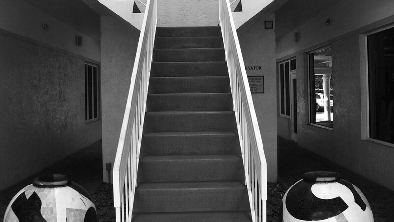 Stairway in Naples Florida and two large urns