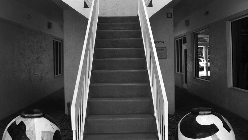 Stairway in Naples Florida and two large urns