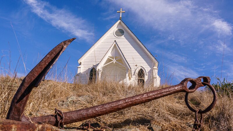 White church, rusted anchor