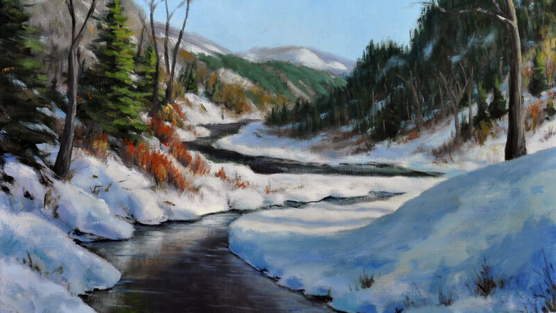 Mountain winter scene with an open water river running though it.