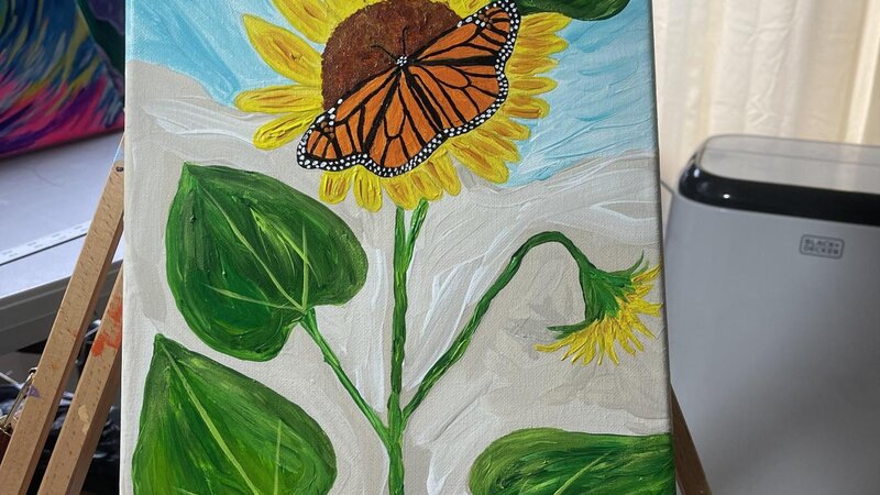 Sunny day sunflower with monarch butterfly in the middle