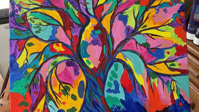 Multicolor tree with tree branches all coming out of the trunk.