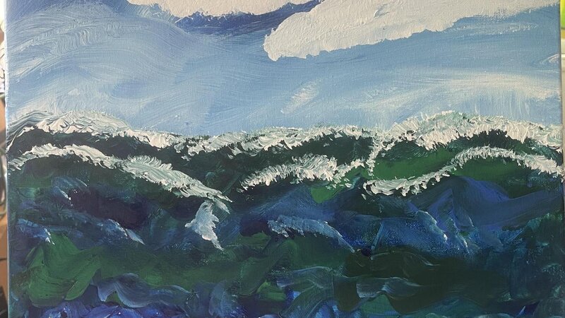 Cloudy sky with wild waves rolling 