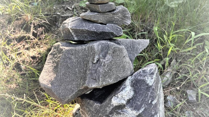 stones stacked by size on grass