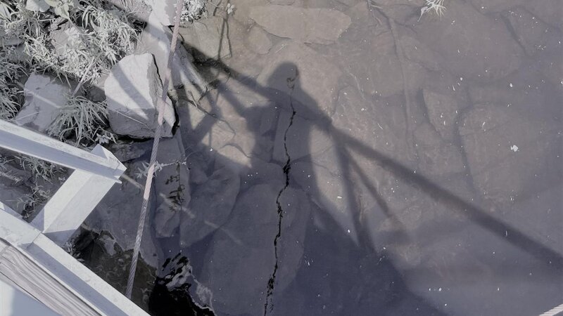 reflection of a person looking down into water