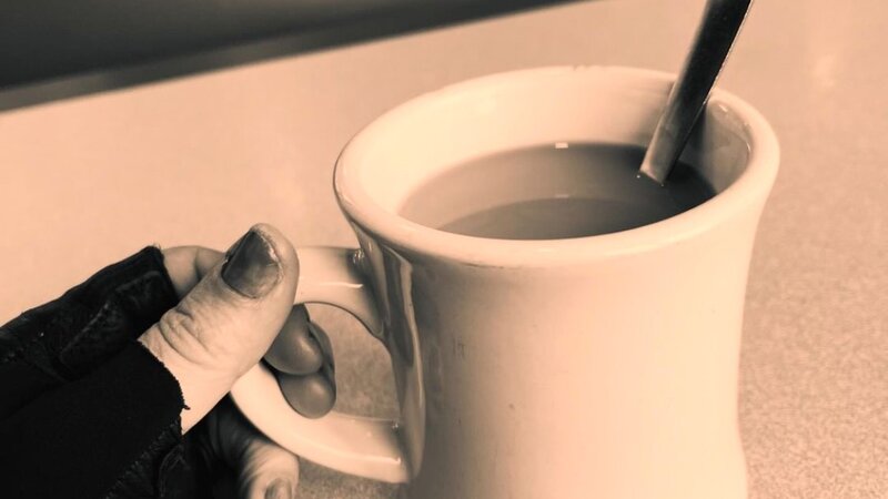 a cup of coffee on a diner table