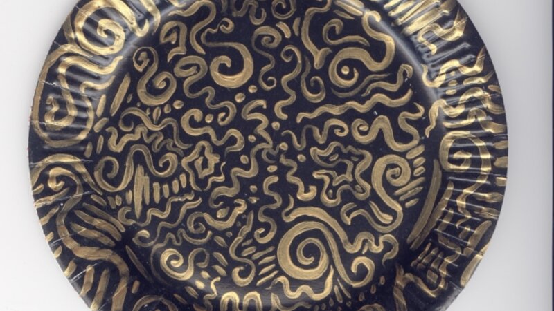 detail of black and gold plate in Dutch Paper Plate Installation