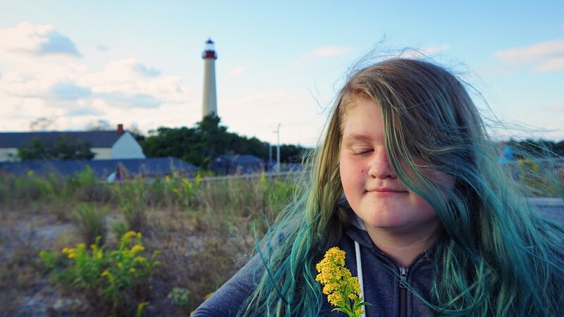 lighthouse, hair, goldenrod, sunset, flowers, girl, clouds, cape may