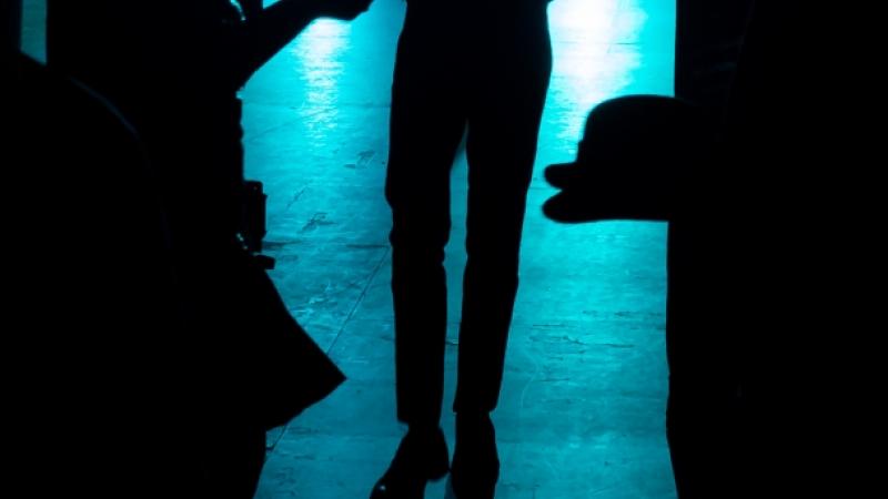 Silhouette of dancer exiting stage with spotlights
