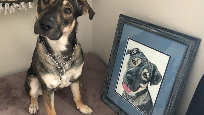 Dog poses with his painted portrait on canvas.