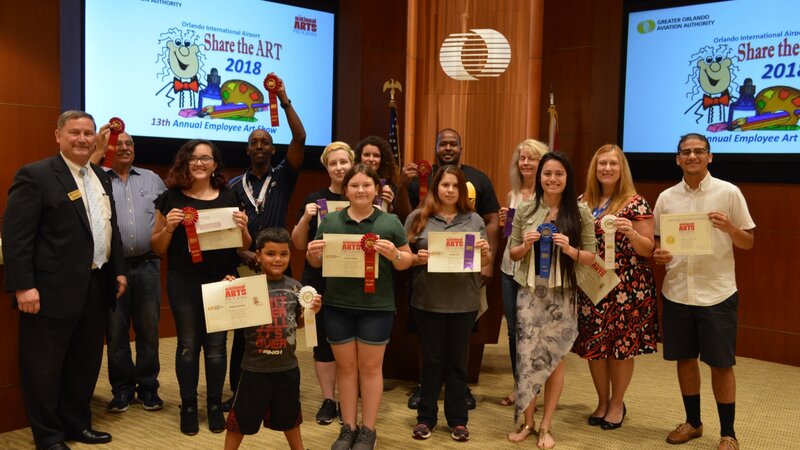 13th Annual Exhibit Proud winners posing with the CEO at the awards reception.