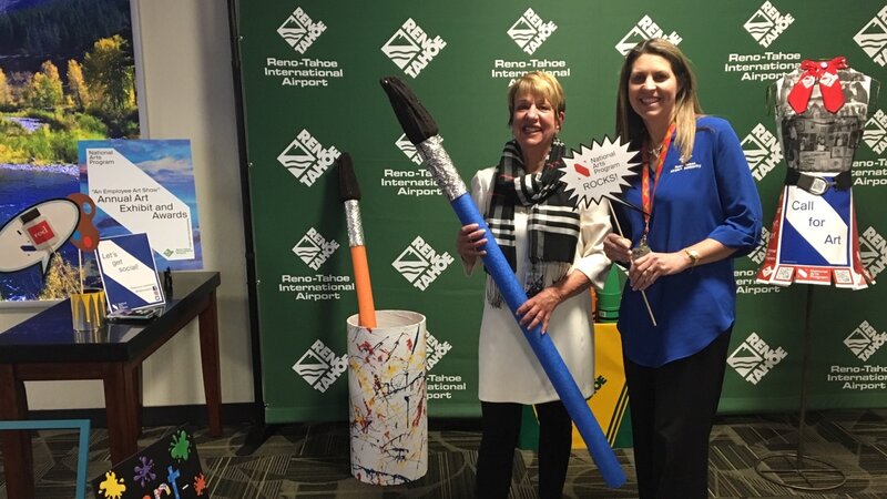 11th Annual Exhibit At the awards reception, coordinator Mary Lee Mansfield and former coordinator Kim Matthews smile at the selfie station.